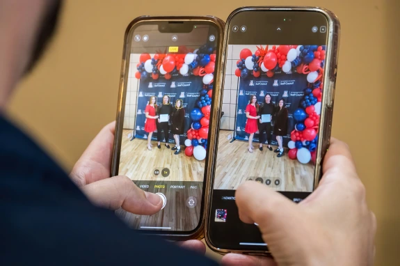 Picture within a picture of photo wall and award recipients